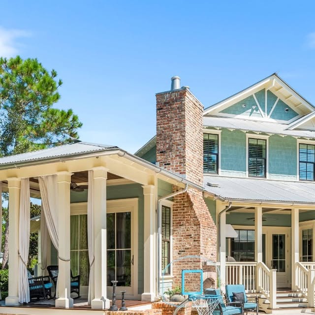 Blue coastal home with wraparound porches in WaterColor